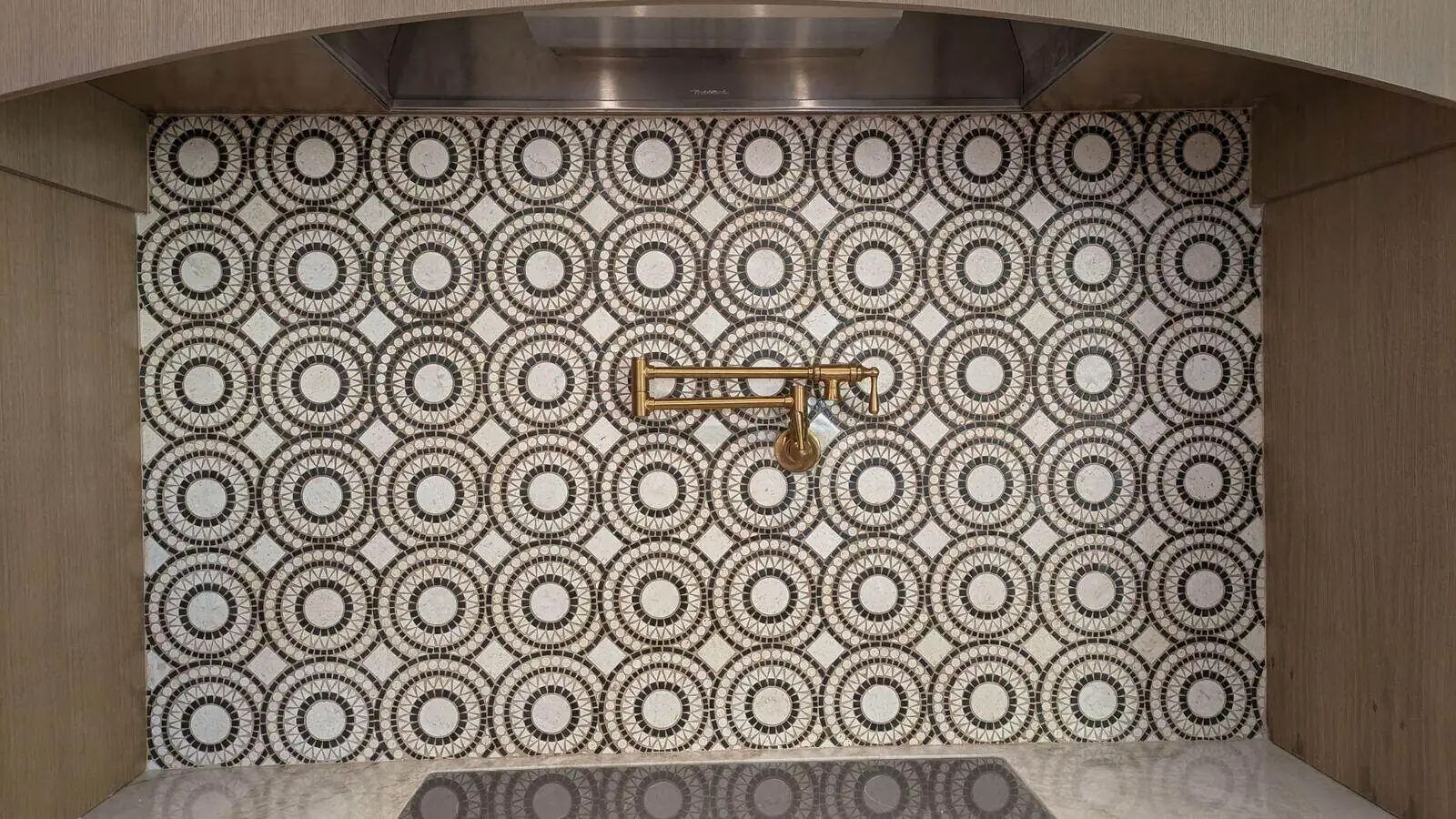 Custom patterned tile kitchen backsplash with pot filler